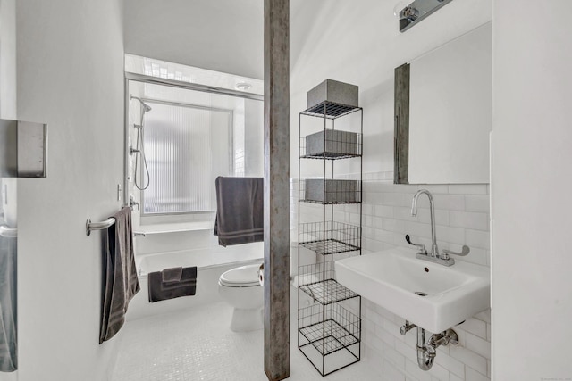 bathroom with tile patterned flooring, backsplash, toilet, and sink