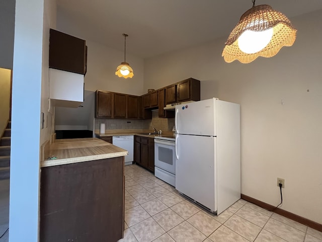 kitchen featuring white appliances, backsplash, sink, light tile patterned floors, and dark brown cabinets