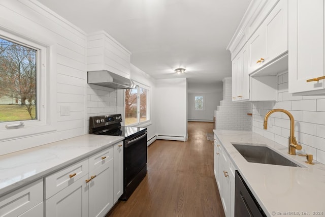 kitchen featuring white cabinetry, black / electric stove, and a wealth of natural light