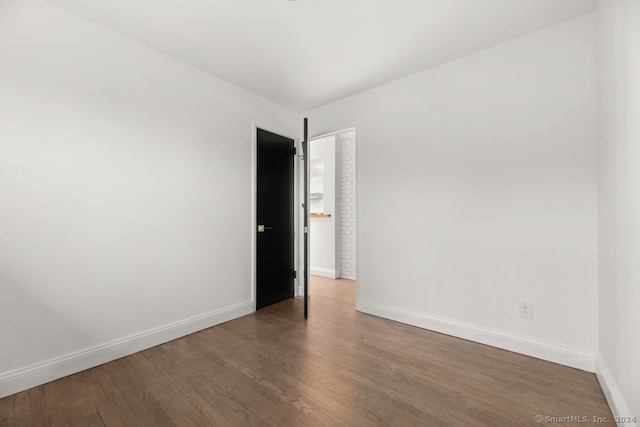 unfurnished room featuring dark hardwood / wood-style flooring