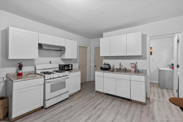 kitchen featuring white range with gas cooktop and white cabinetry