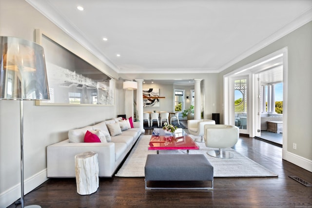 living room with dark hardwood / wood-style floors, ornate columns, and ornamental molding