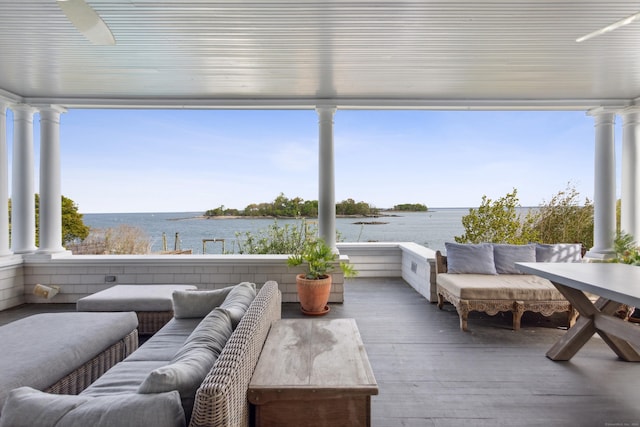 sunroom / solarium featuring a water view