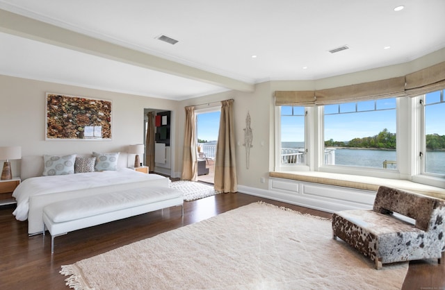 bedroom featuring a water view and dark wood-type flooring