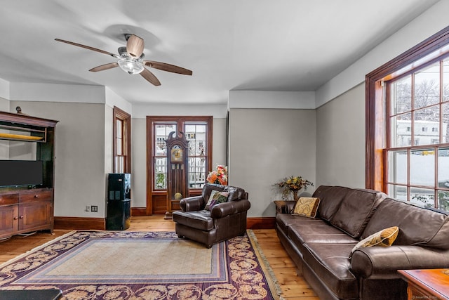 living room with ceiling fan and light wood-type flooring