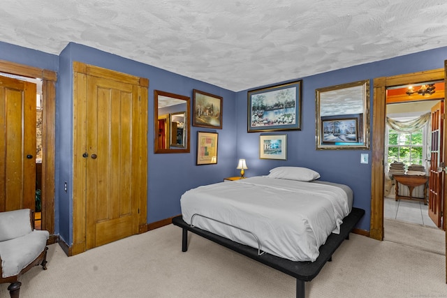 carpeted bedroom featuring a textured ceiling