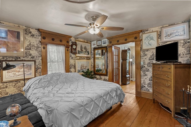 bedroom with ceiling fan and wood-type flooring