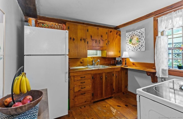 kitchen featuring sink, light hardwood / wood-style floors, and white appliances