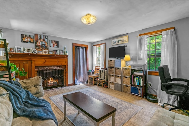 living room with light hardwood / wood-style floors, a wealth of natural light, and a brick fireplace