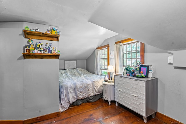 bedroom featuring dark hardwood / wood-style floors and lofted ceiling