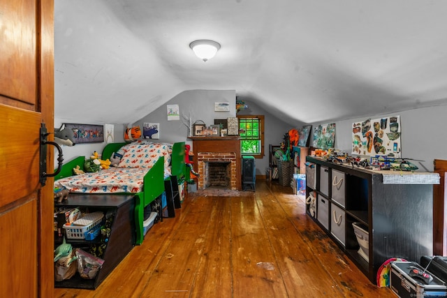 rec room with a fireplace, dark hardwood / wood-style floors, and vaulted ceiling