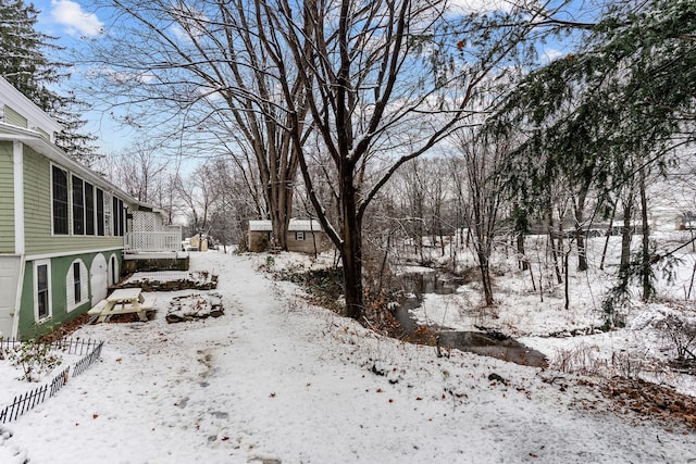 snowy yard with a wooden deck