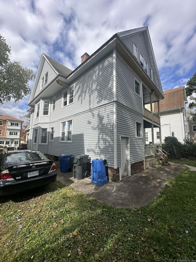 view of side of property with a yard