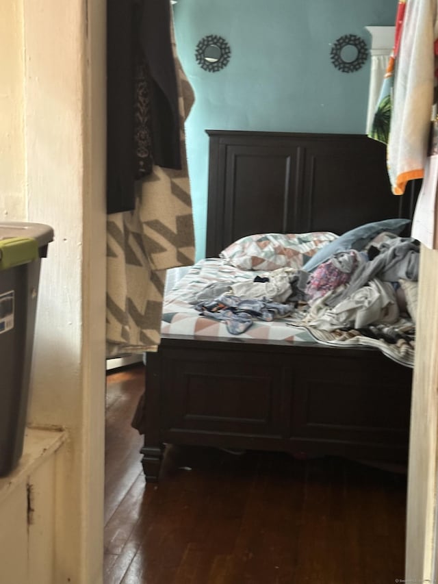 bedroom with dark wood-type flooring