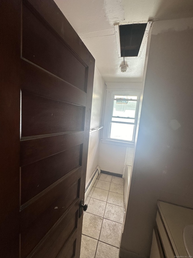 interior space featuring baseboard heating and tile patterned floors