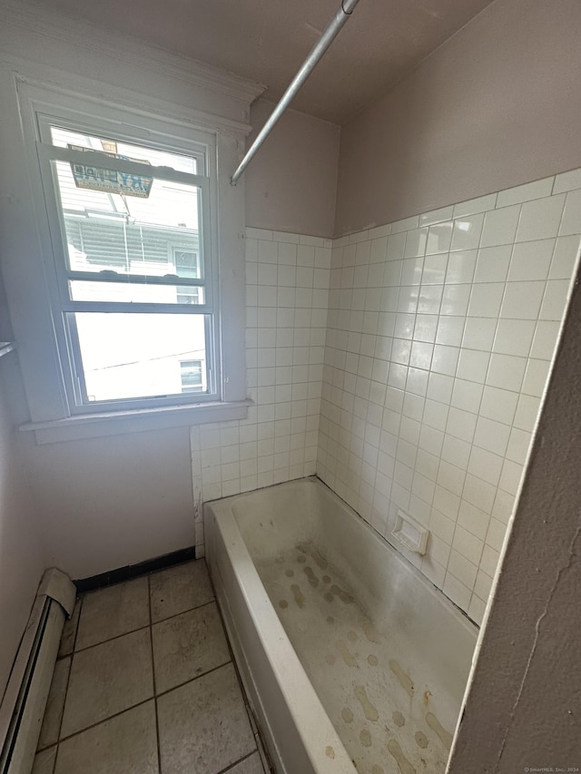 bathroom with tile patterned flooring, a baseboard radiator, and tiled shower / bath