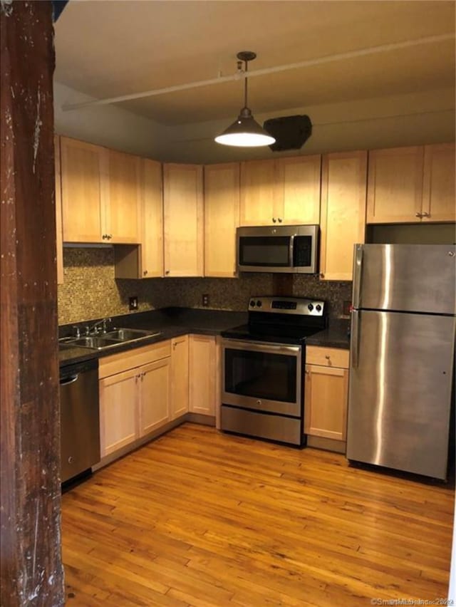 kitchen featuring light brown cabinets, stainless steel appliances, light hardwood / wood-style flooring, and sink