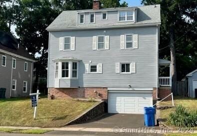 view of front of house featuring a front yard and a garage