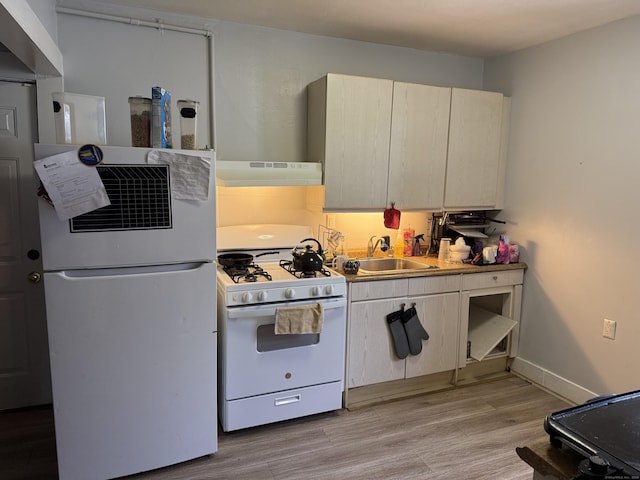 kitchen with sink, light hardwood / wood-style flooring, ventilation hood, white appliances, and cream cabinetry