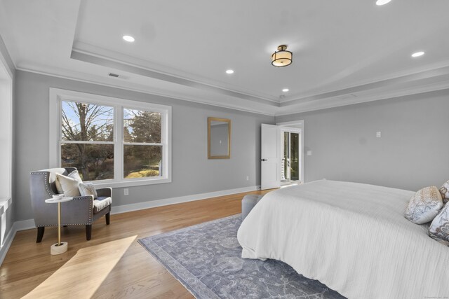 bedroom featuring crown molding and light hardwood / wood-style floors