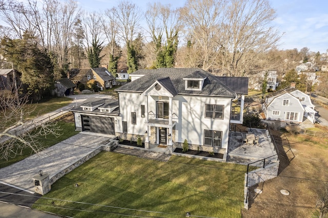 view of front of property with a front yard and a balcony