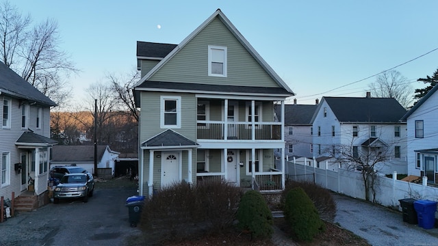 front facade featuring covered porch and a balcony