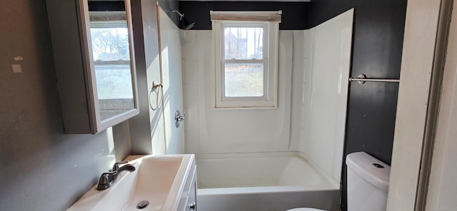 full bathroom featuring bathing tub / shower combination, vanity, and toilet