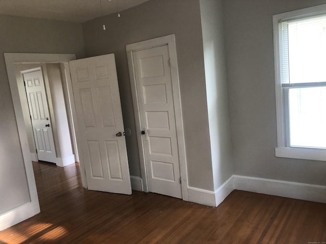 unfurnished bedroom featuring dark hardwood / wood-style floors