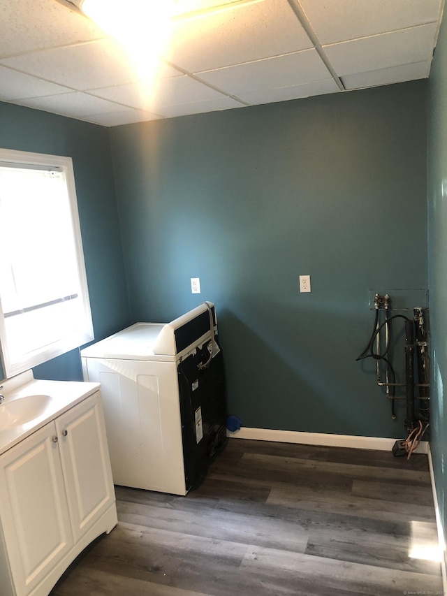 washroom featuring cabinets, washer / dryer, dark hardwood / wood-style floors, and sink