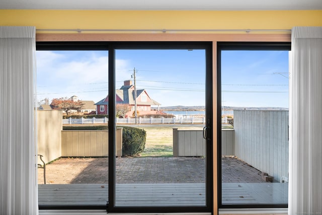 entryway featuring a wealth of natural light and a water view