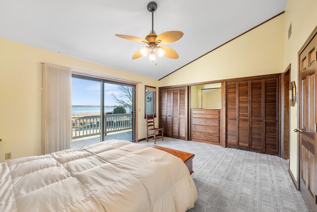 bedroom with access to outside, light colored carpet, ceiling fan, a water view, and high vaulted ceiling