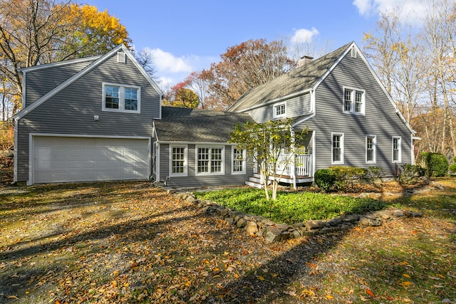 back of property with a garage