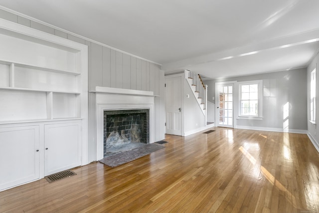 149 Chestnut Ridge Rd, Bethel, CT 06801 - unfurnished living room with stairway, wood finished floors, crown molding, and a large fireplace