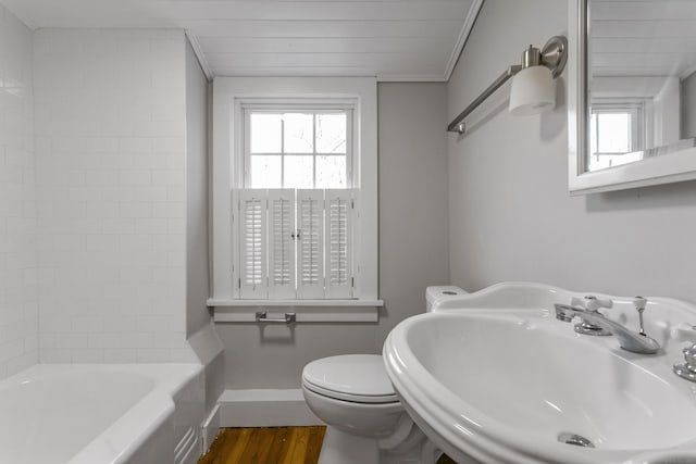 bathroom with sink, hardwood / wood-style floors, toilet, a bathtub, and ornamental molding