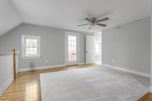 unfurnished room with light hardwood / wood-style floors, vaulted ceiling, and ceiling fan