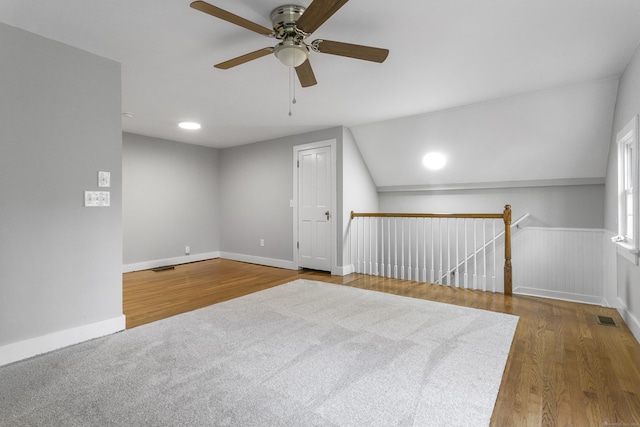 additional living space with wood-type flooring, vaulted ceiling, and ceiling fan