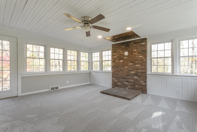 unfurnished sunroom featuring ceiling fan and plenty of natural light