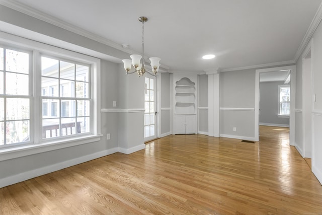 unfurnished dining area featuring an inviting chandelier, a healthy amount of sunlight, and light hardwood / wood-style floors