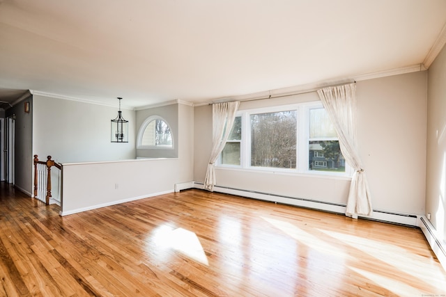 unfurnished room featuring hardwood / wood-style flooring, ornamental molding, and a baseboard radiator