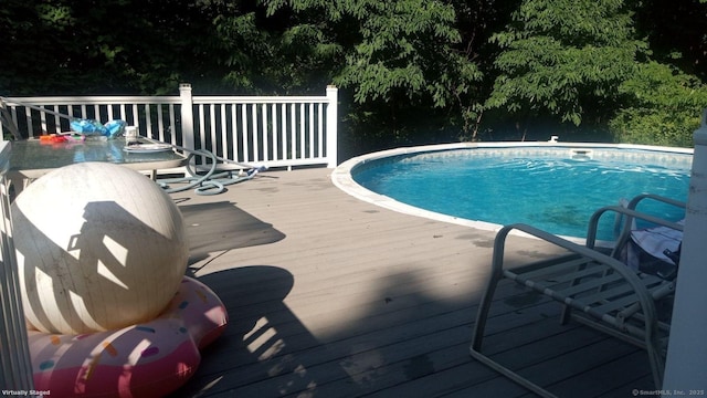 view of pool with a wooden deck