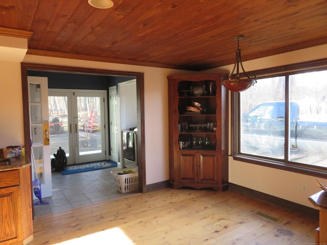 dining room featuring wood ceiling, light wood-type flooring, baseboards, and visible vents