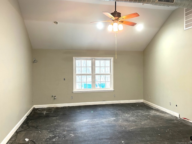 empty room with a ceiling fan, concrete floors, baseboards, and vaulted ceiling