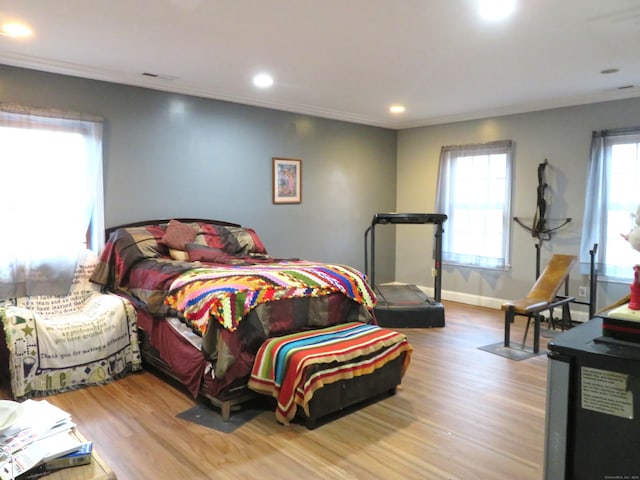 bedroom featuring crown molding, recessed lighting, wood finished floors, and baseboards