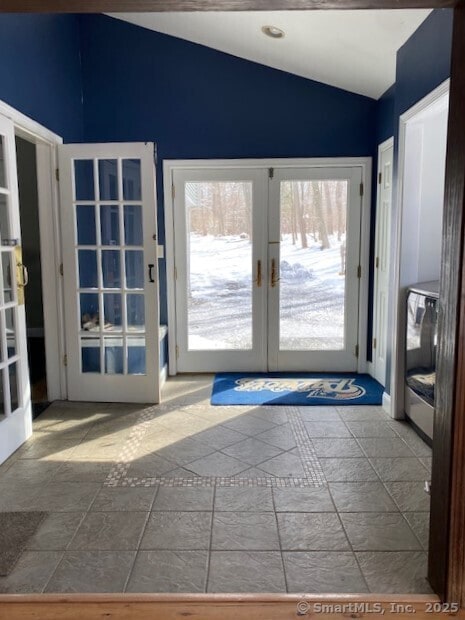 doorway with french doors and lofted ceiling