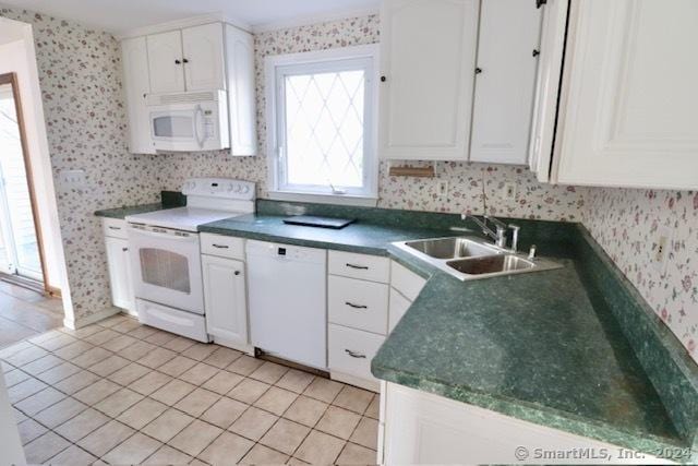 kitchen with white cabinetry, sink, light tile patterned floors, and white appliances