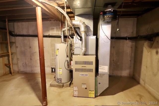 utility room with heating unit and water heater