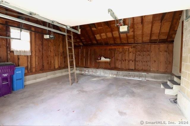 garage featuring wood walls