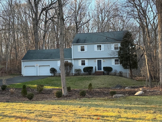 view of front of property with a garage and a front yard