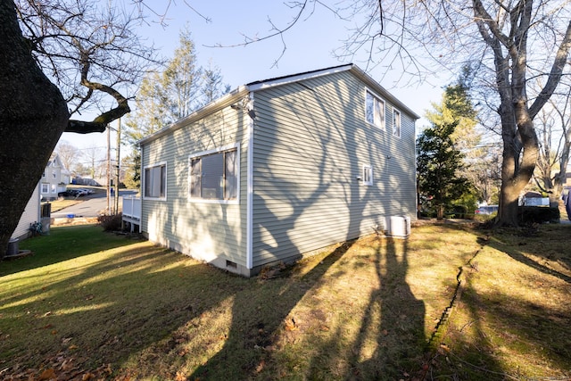 view of side of home featuring a lawn