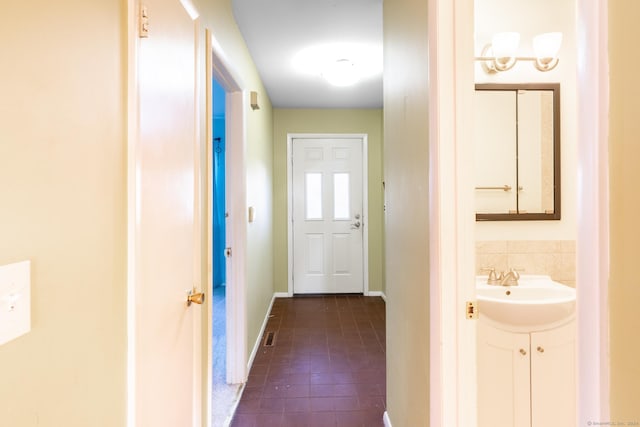 corridor with dark tile patterned flooring